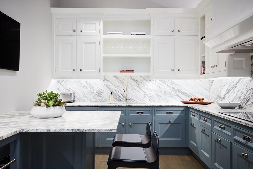 240 Devonshire Street, Unit PH 2A Boston, MA 02110 - Photo 6 of 42 a living room with granite countertop white cabinets and flat screen tv