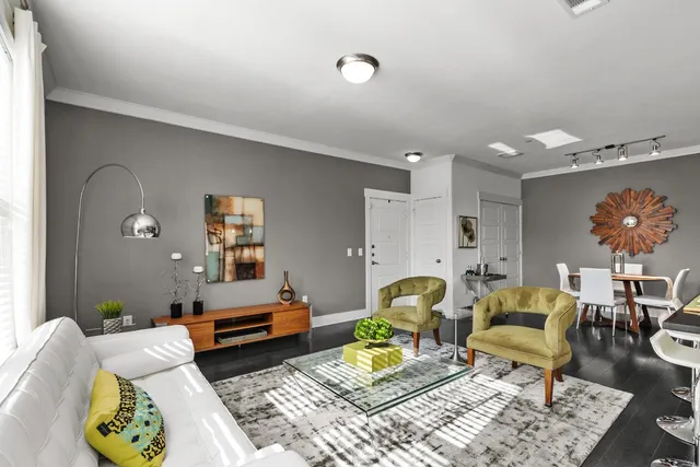 a living room with furniture and wooden floor