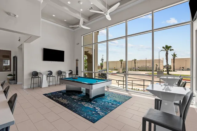 a living room with couches a coffee table and with flat screen tv