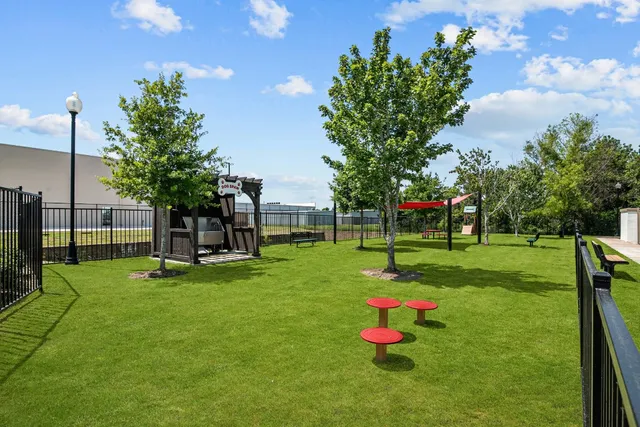 a garden with trees in the background