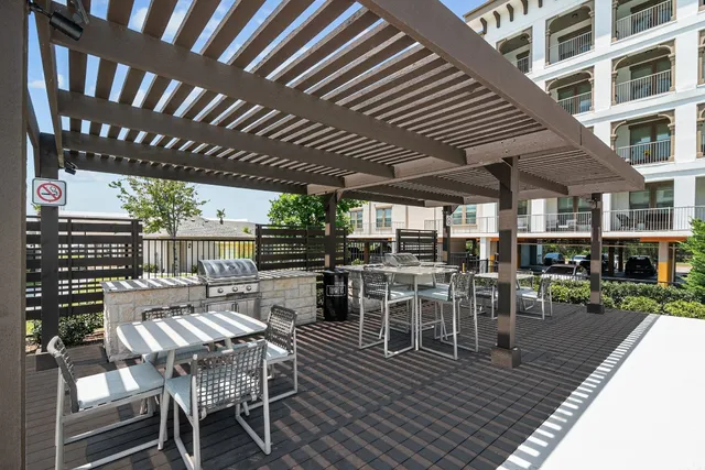 a view of a patio with table and chairs