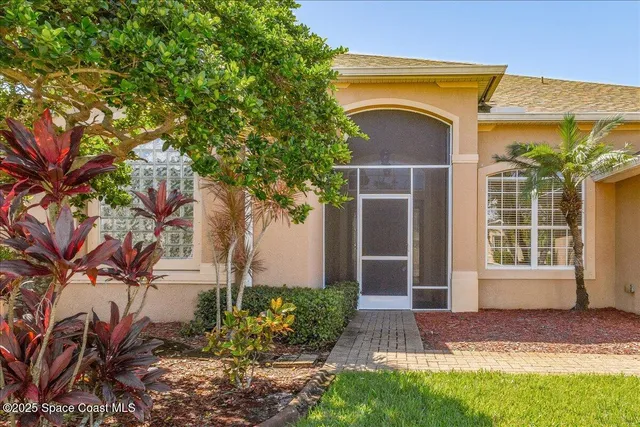 an empty room to ceiling fan and windows