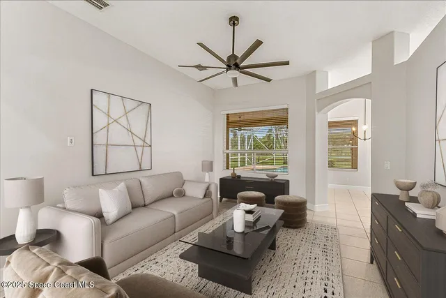 a living room with stainless steel appliances kitchen island granite countertop furniture and a large window