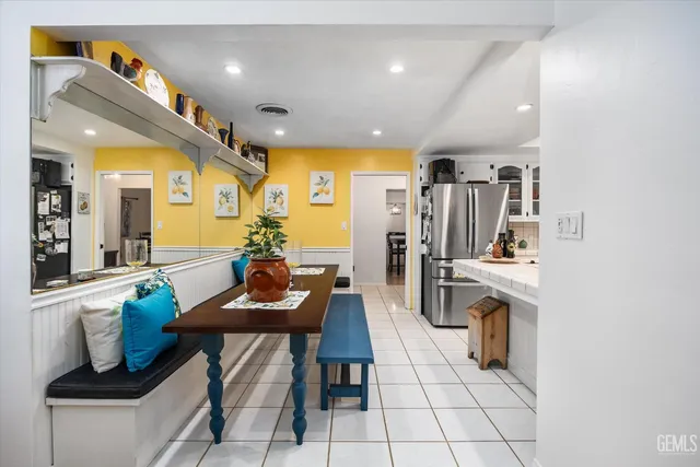 a living room with stainless steel appliances kitchen island granite countertop furniture and a dining table