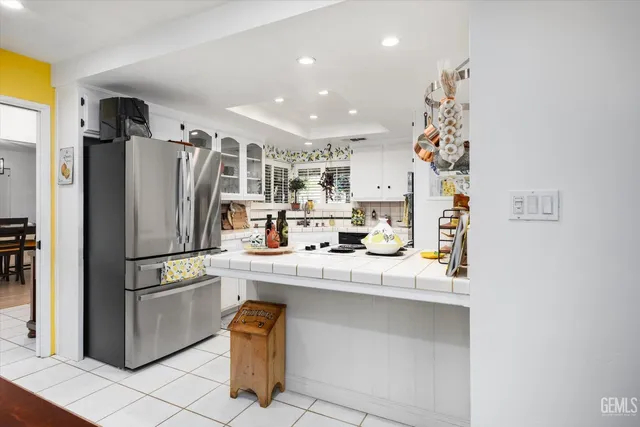 a kitchen with stainless steel appliances granite countertop a refrigerator and sink