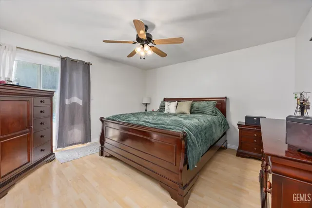 a large bedroom with a large bed and a chandelier