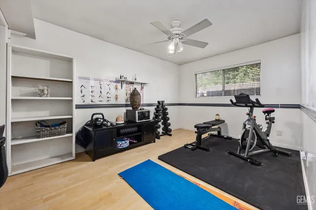 a living room with furniture gym equipment and a window