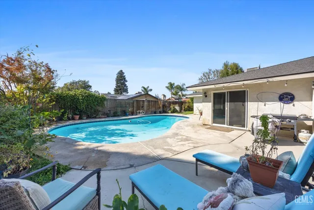 a view of a swimming pool with a yard