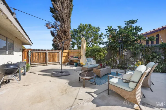 a view of a patio with table and chairs and potted plants