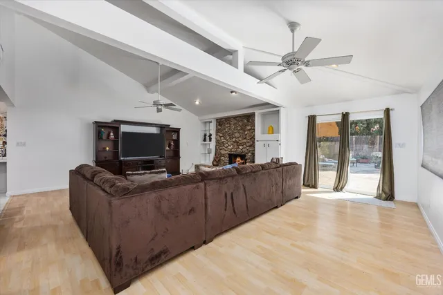 a view of a kitchen with furniture and stainless steel appliances