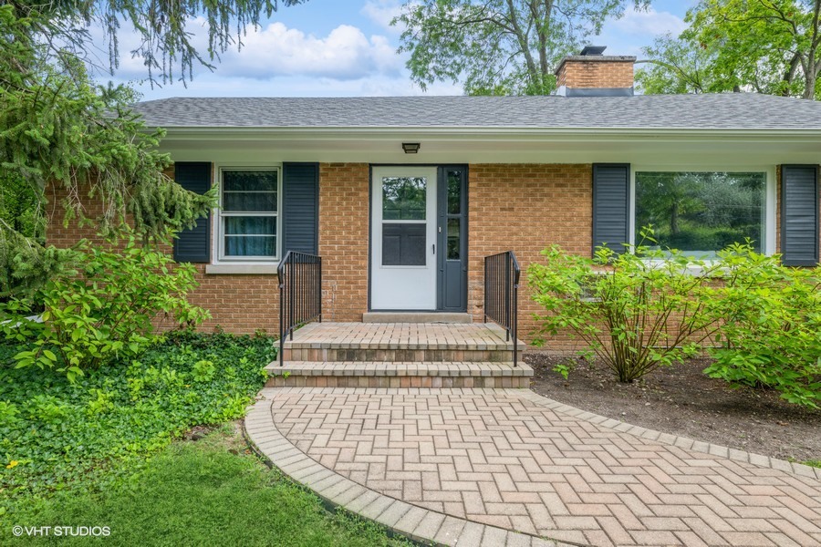 107 Ridge Road Highland Park, IL 60035 - Photo 1 of 20 a front view of a house with a garden