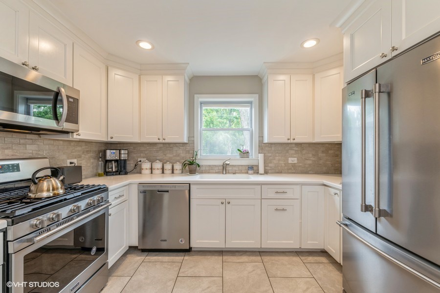 107 Ridge Road Highland Park, IL 60035 - Photo 5 of 20 a kitchen with a sink stove and refrigerator