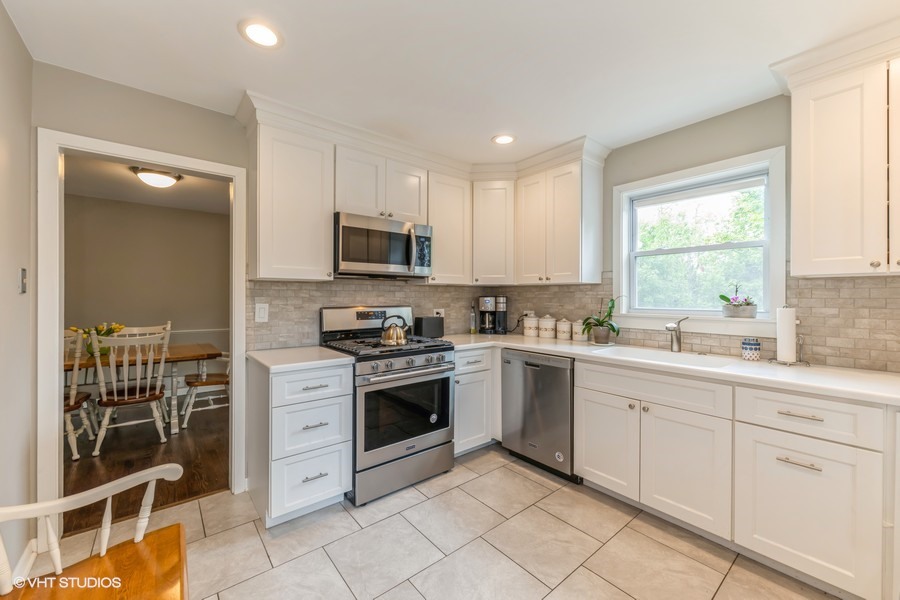 107 Ridge Road Highland Park, IL 60035 - Photo 6 of 20 a kitchen with white cabinets appliances and a window