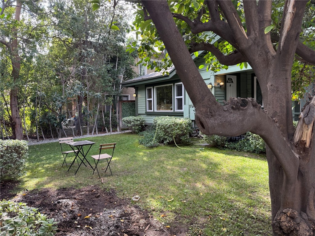a view of a house with a yard in a forest
