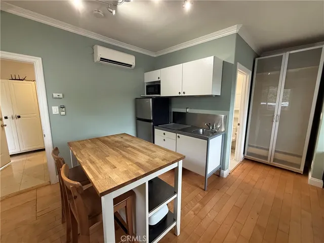 a kitchen that has a table and chairs in it