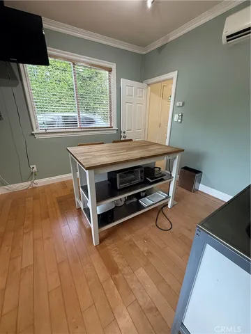 a room with wooden floor and furniture