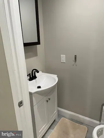 a bathroom with a sink and mirror