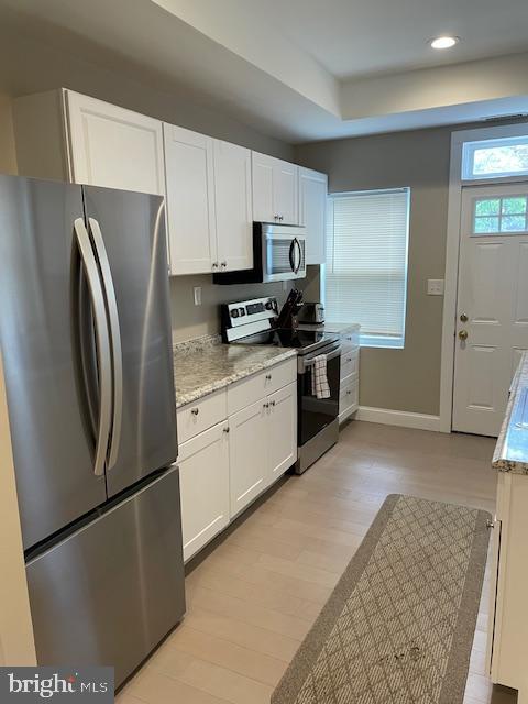 906 I Street Southeast, Unit 2 Washington, DC 20003 - Photo 4 of 14 a kitchen with stainless steel appliances granite countertop a refrigerator a stove a sink and white cabinets