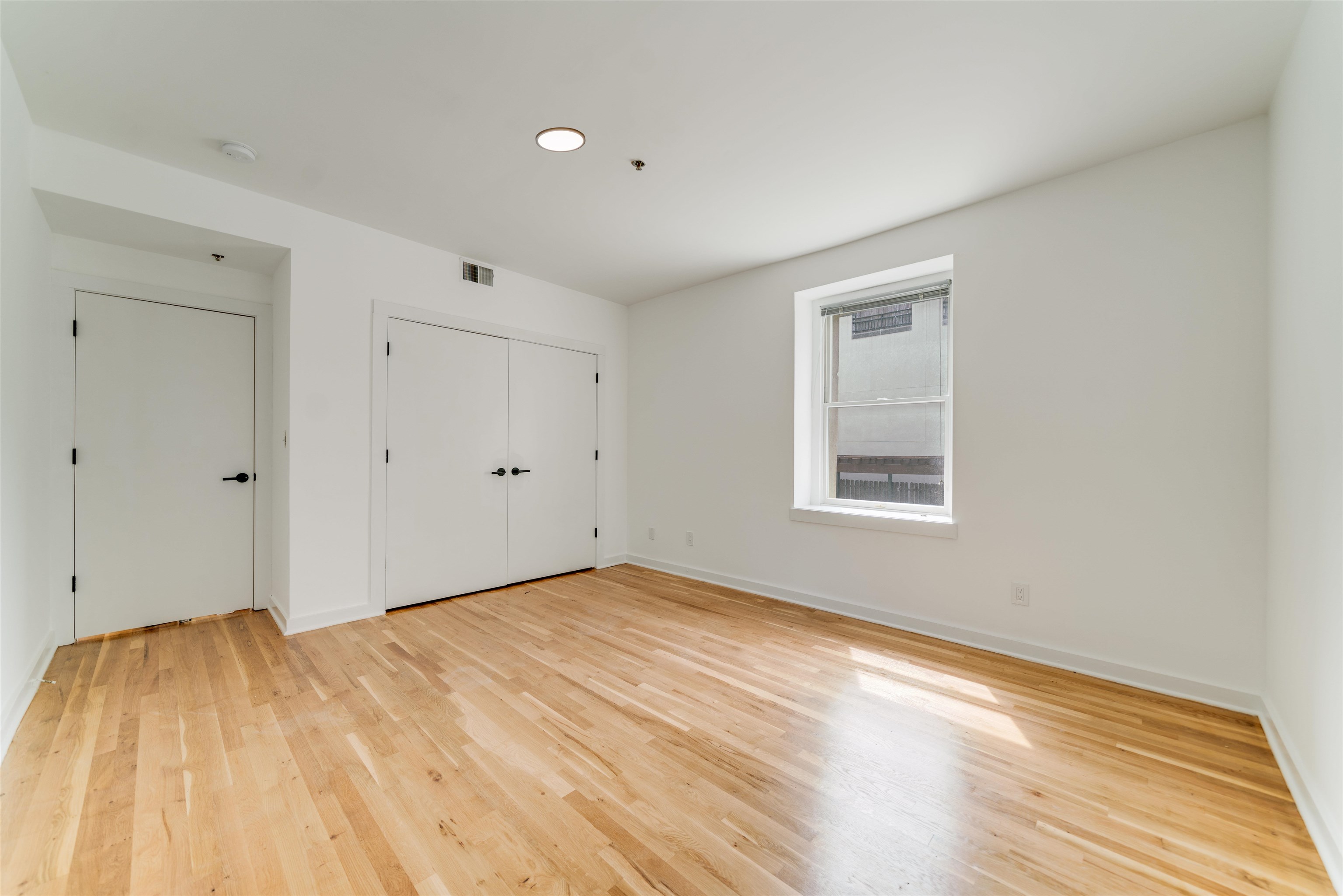 716 Madison Street, Unit 110A Hoboken, NJ 07030 - Photo 11 of 15 a view of empty room with wooden floor