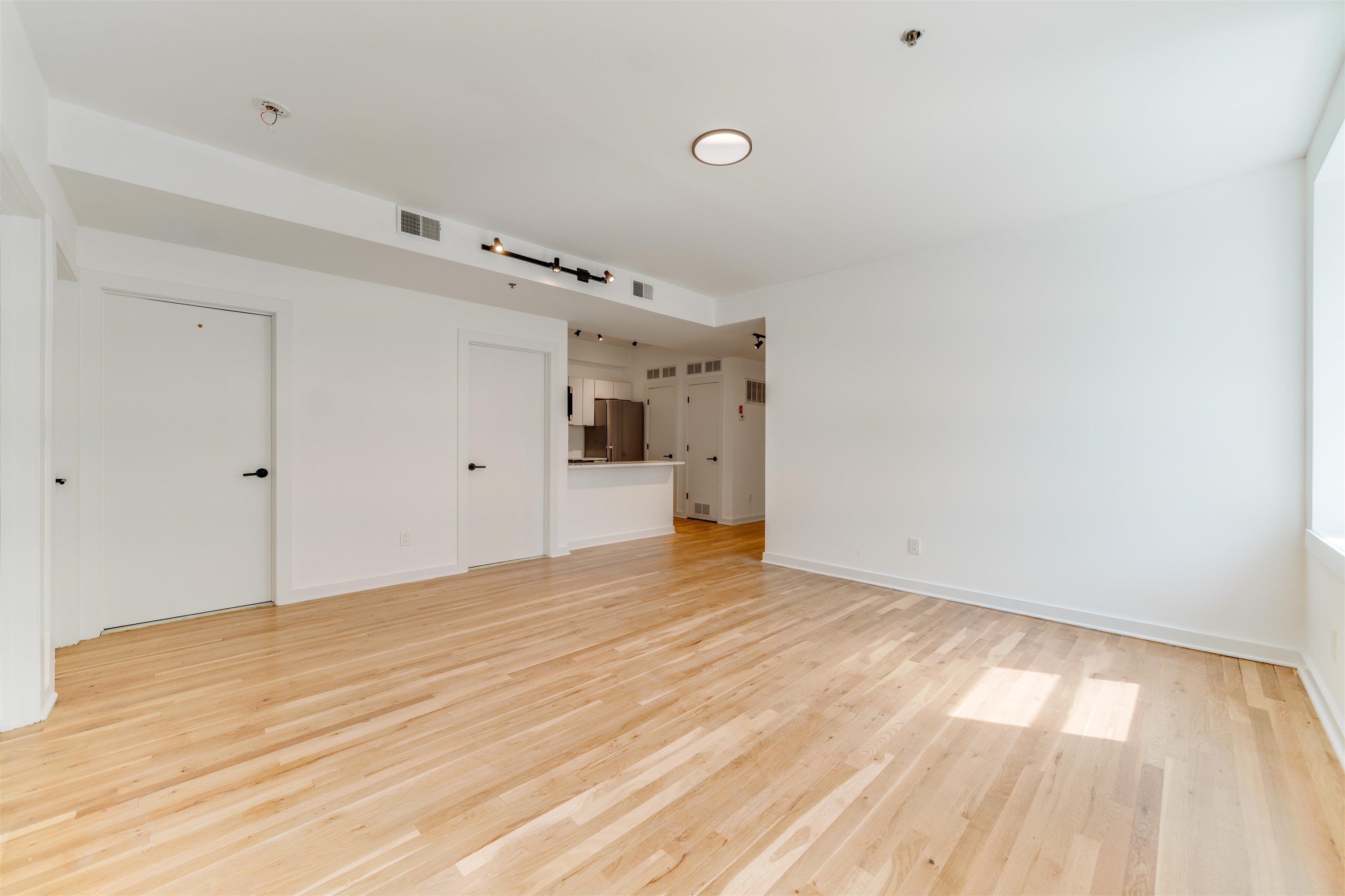 716 Madison Street, Unit 110A Hoboken, NJ 07030 - Photo 3 of 15 a view of empty room with wooden floor