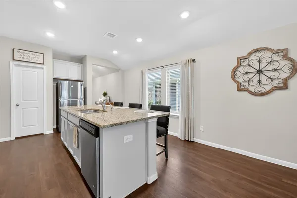a kitchen with a sink and a refrigerator