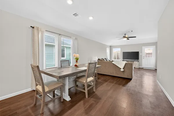 a view of a dining room with furniture window and wooden floor