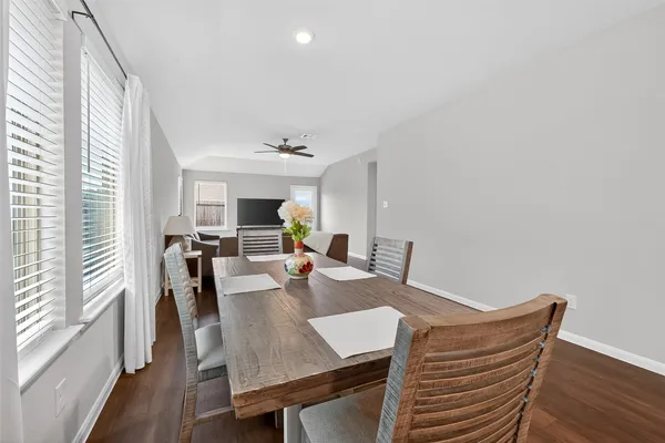 a view of a dining room with furniture window and wooden floor
