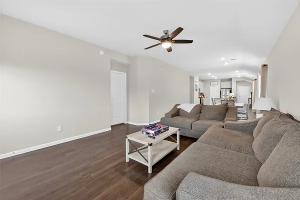 a living room with furniture and a wooden floor