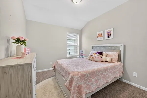 a bedroom with a bed and a table