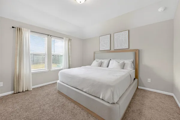 a bedroom with a bed lamp and window