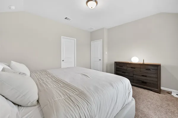 a bedroom with a bed and a lamp