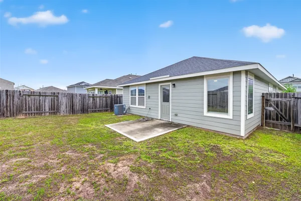 a view of a house with a yard and sitting area