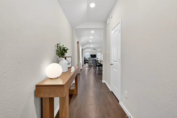 a kitchen with wooden floor and breakfast area