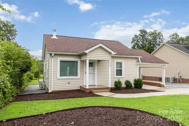 a front view of a house with a garden and plants