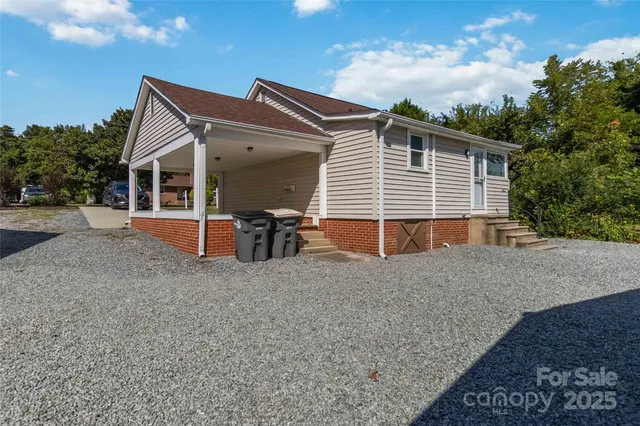 a view of house with a yard and seating space