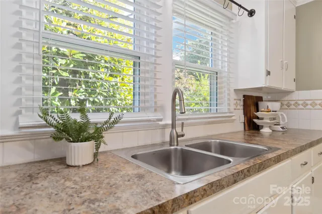 a kitchen with a sink a counter and window