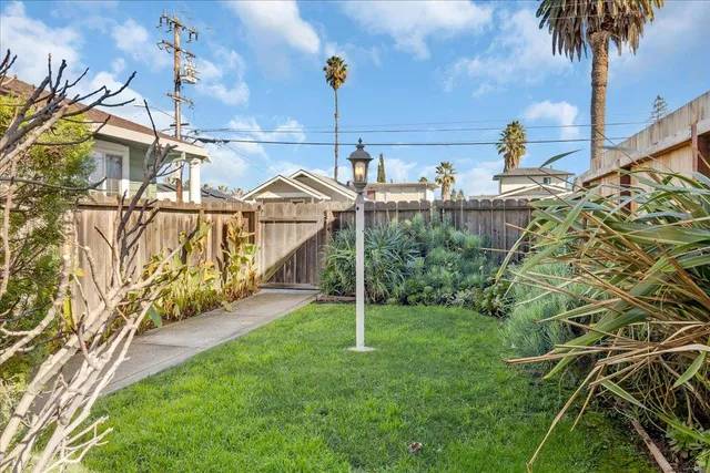a view of a garden with a house in the background