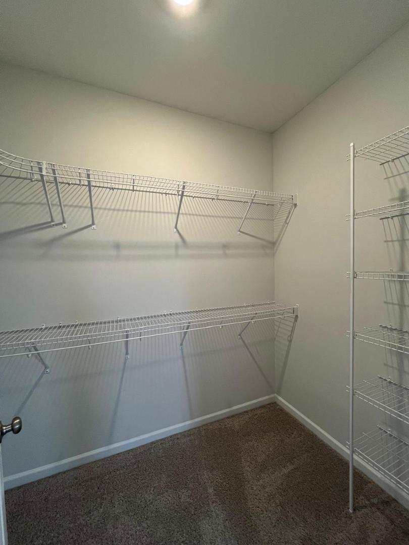 183 Chesapeake Commons Street Garner, NC 27529 - Photo 11 of 26 a view of a room with racks on the wall