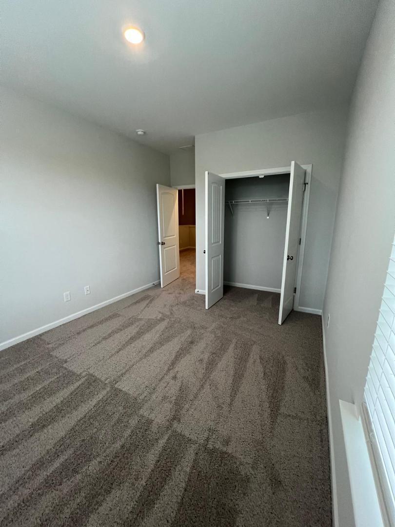 183 Chesapeake Commons Street Garner, NC 27529 - Photo 20 of 26 an empty room with a natural light