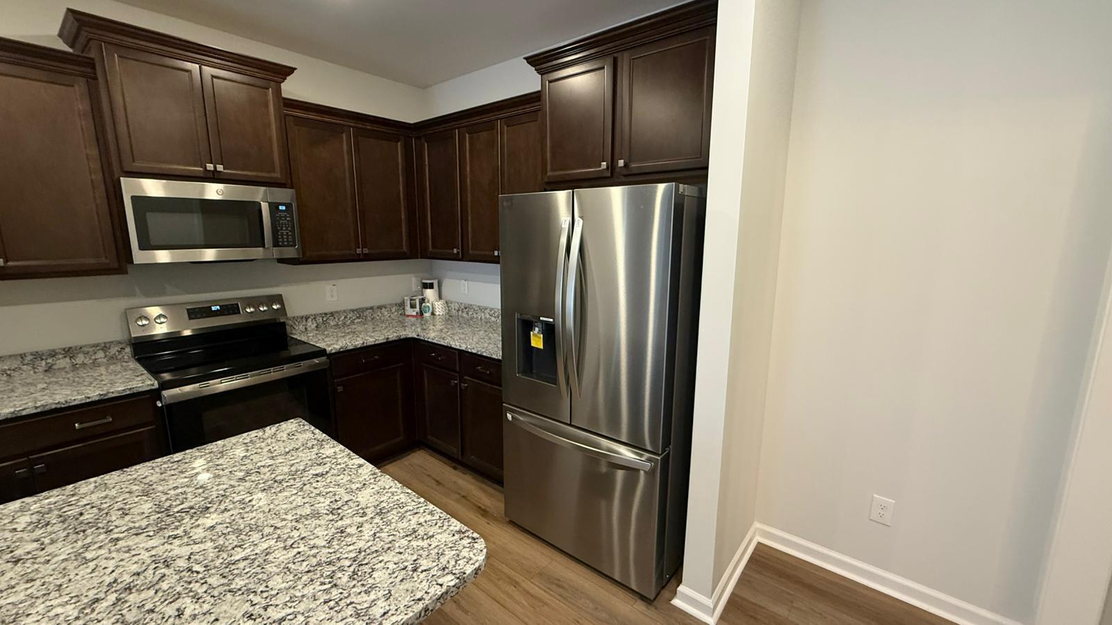 183 Chesapeake Commons Street Garner, NC 27529 - Photo 23 of 26 a kitchen with a refrigerator stove and microwave