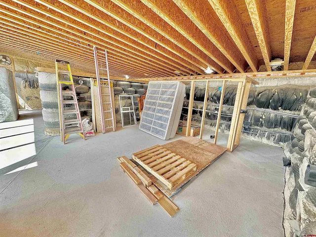 a view of a patio with a dining table and chairs with wooden floor