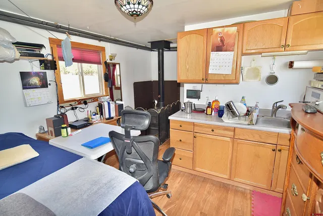 a front view of a house with a yard and mountain view in back
