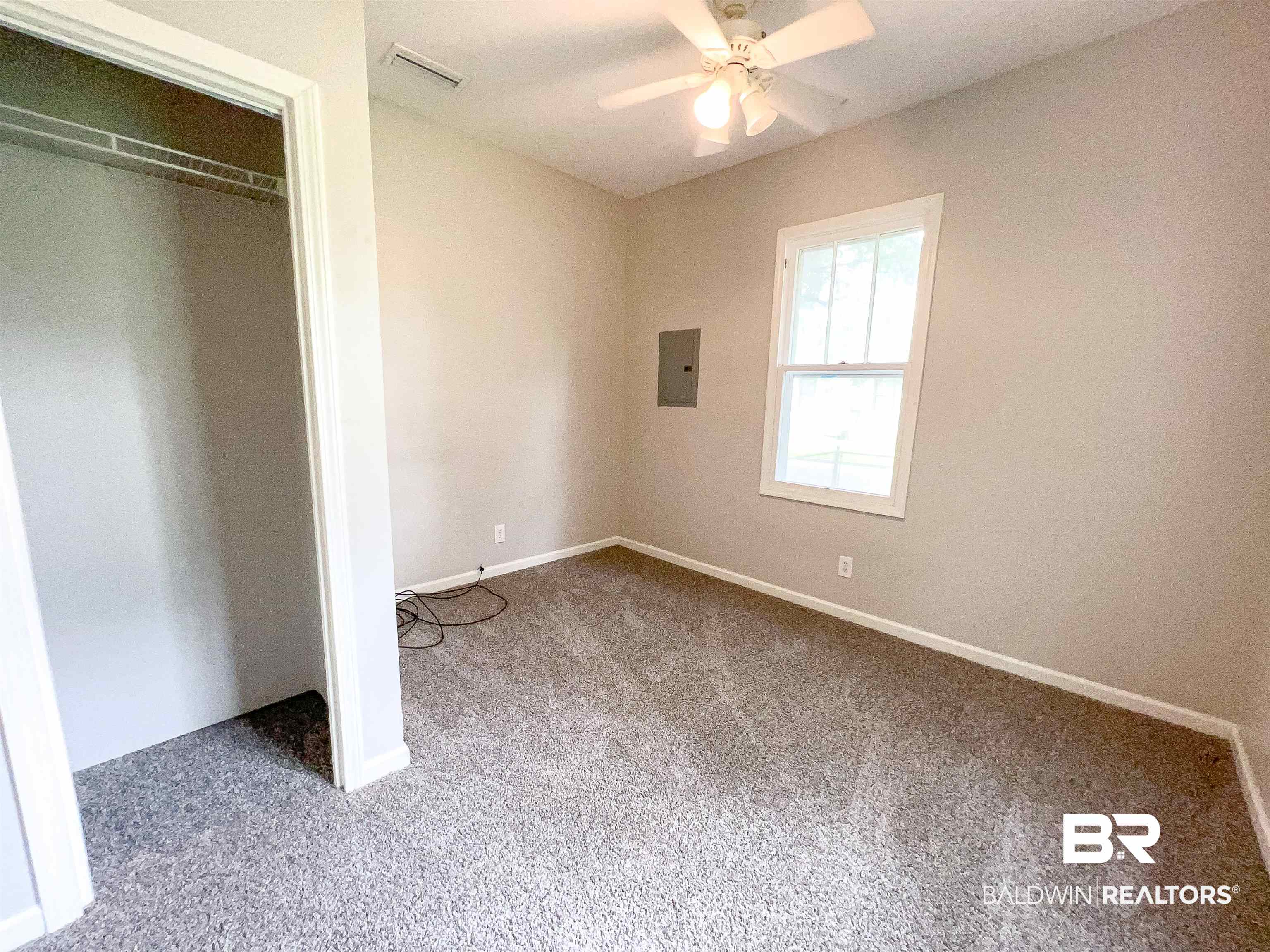 1164 Seneca Street Mobile, AL 36605 - Photo 16 of 22 Unfurnished bedroom with carpet floors, a closet, electric panel, and visible vents