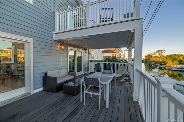 a view of a deck with wooden floor and outdoor seating