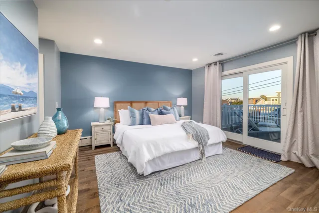 a bedroom with a large bed and a large window