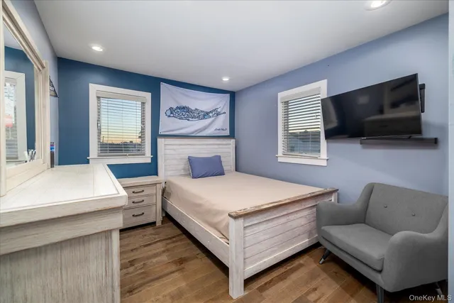 a bedroom with a bed and a flat screen television
