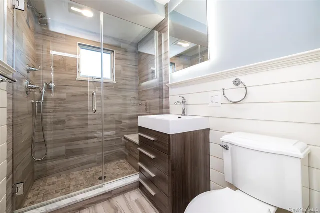 a bathroom with a sink toilet and shower