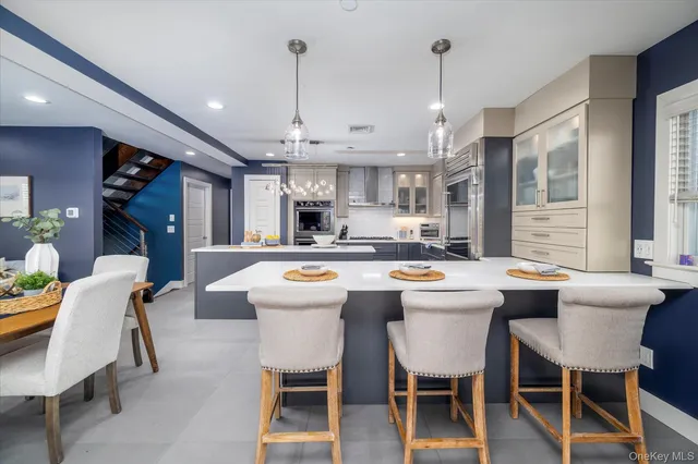 a kitchen that has a lot of cabinets in it with a dining table and chairs