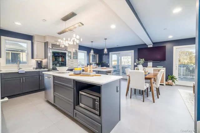 a kitchen with stainless steel appliances kitchen island granite countertop a sink and cabinets