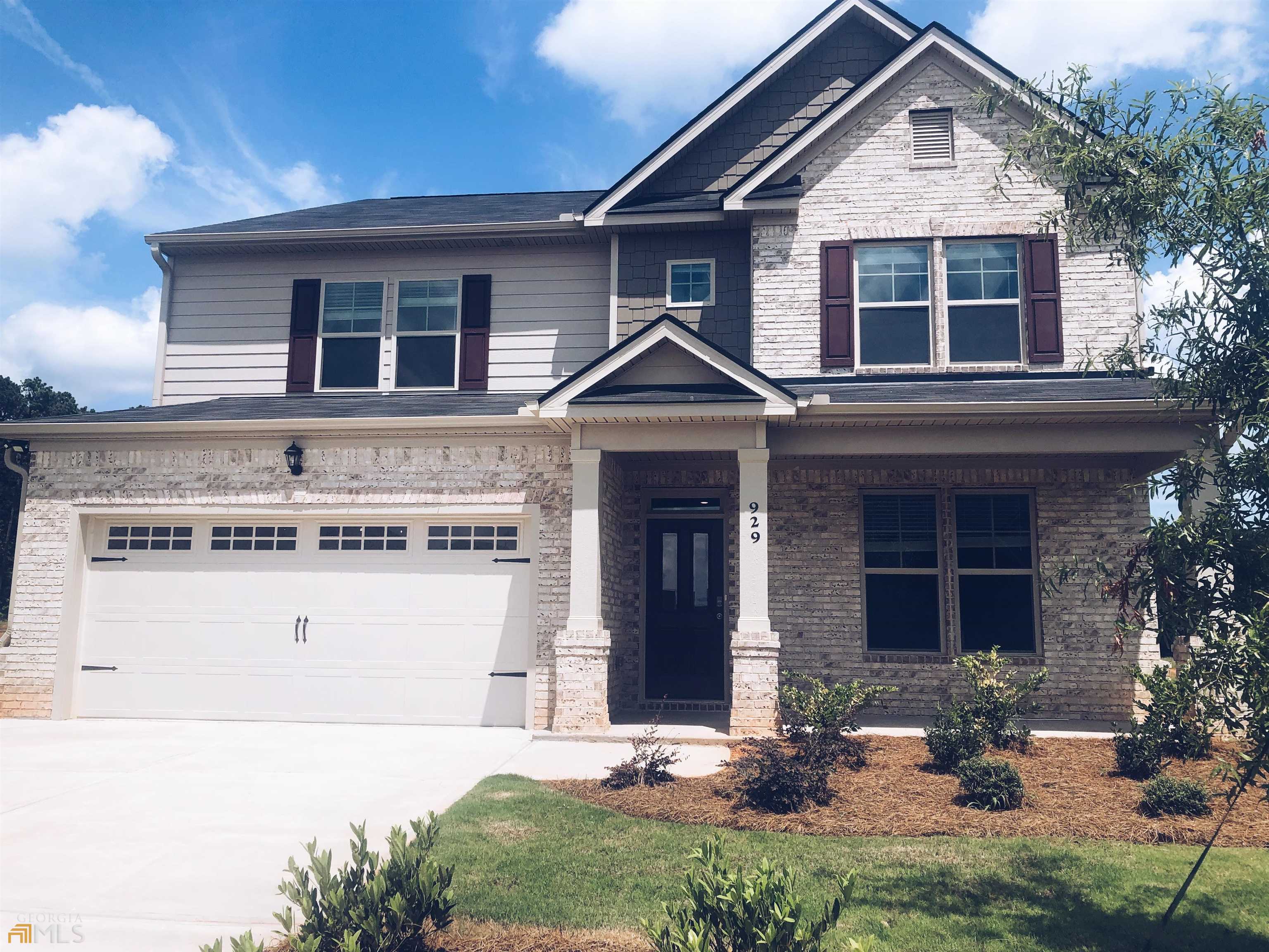 929 Eldridge Road, Unit 82 Hampton, GA 30228 - Photo 1 of 1 a front view of a house with a yard